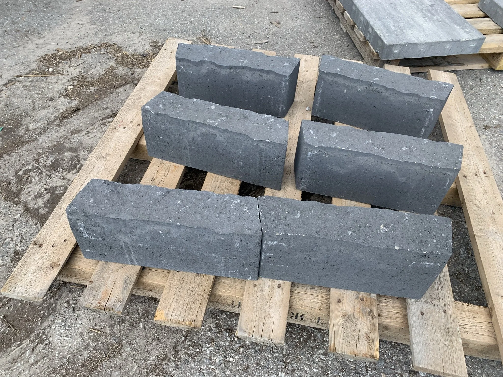 Gray concrete blocks arranged on a wooden pallet