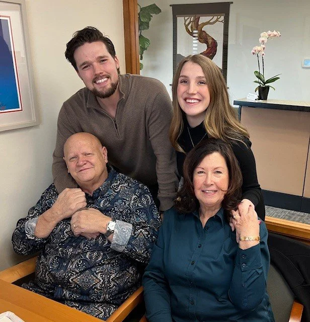 The couple standing are the buyers; the couple seated are the sellers.