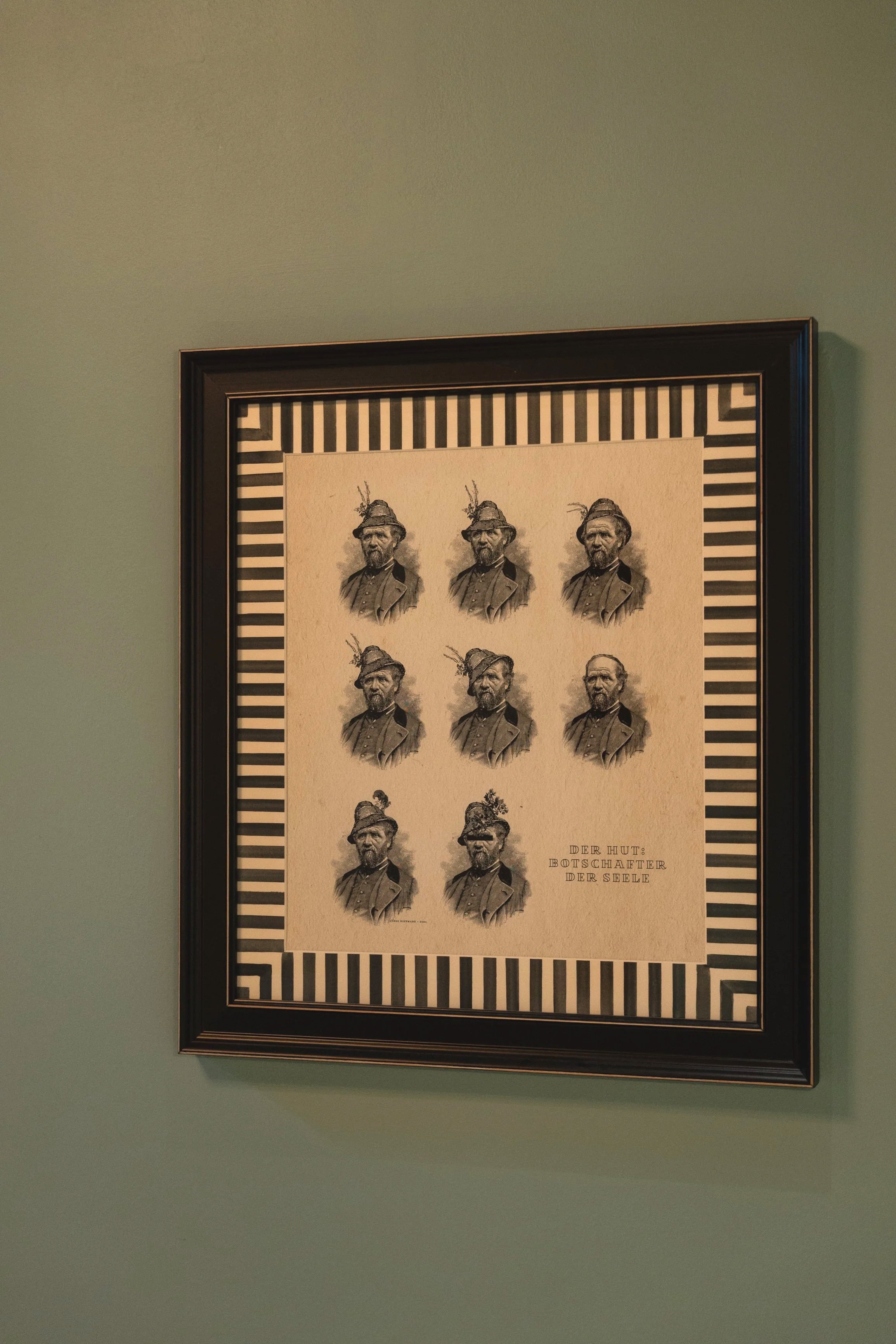 Framed vintage-style poster with multiple black-and-white images of a man in a 19th-century uniform, with a striped border and German text at the bottom.