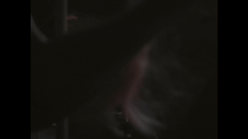 Dark image with faint, blurry outline of a person’s face, difficult to distinguish details.
