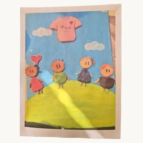 Anti-bullying poster created by a youth with four painted kid characters with a heart and a be kind t-shirt