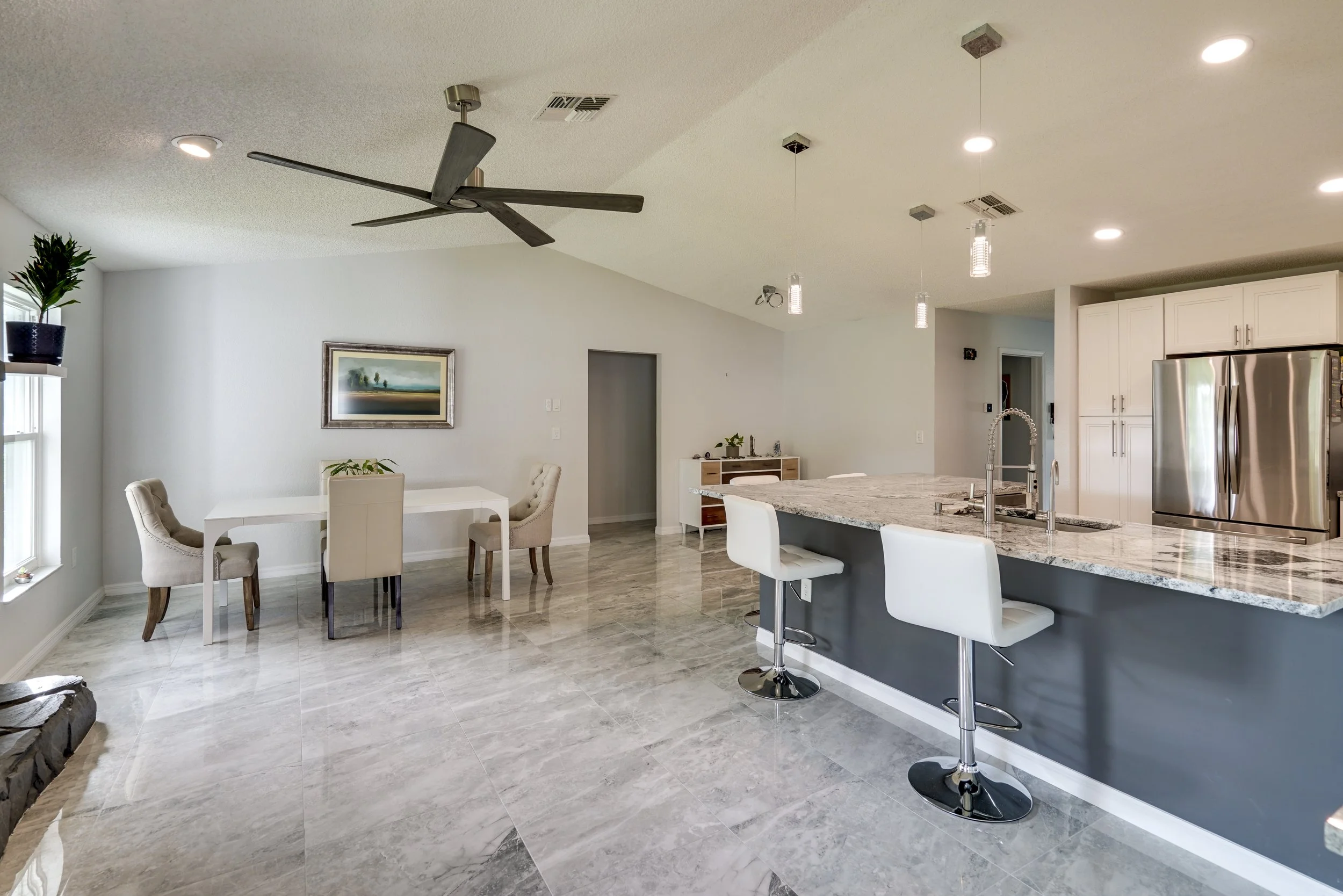 Full interior remodeling project in Spring Hill, FL featuring an open-concept living space, custom kitchen, and large format tile flooring