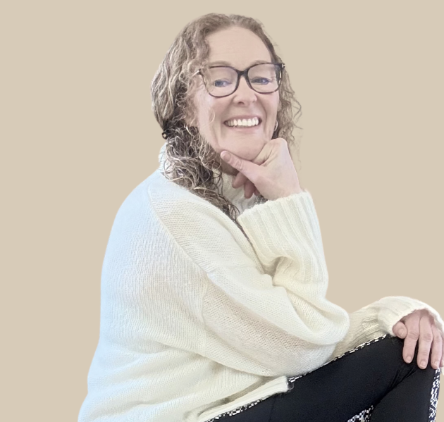 Lynda Greeves looking at the camera wearing a cream jumper