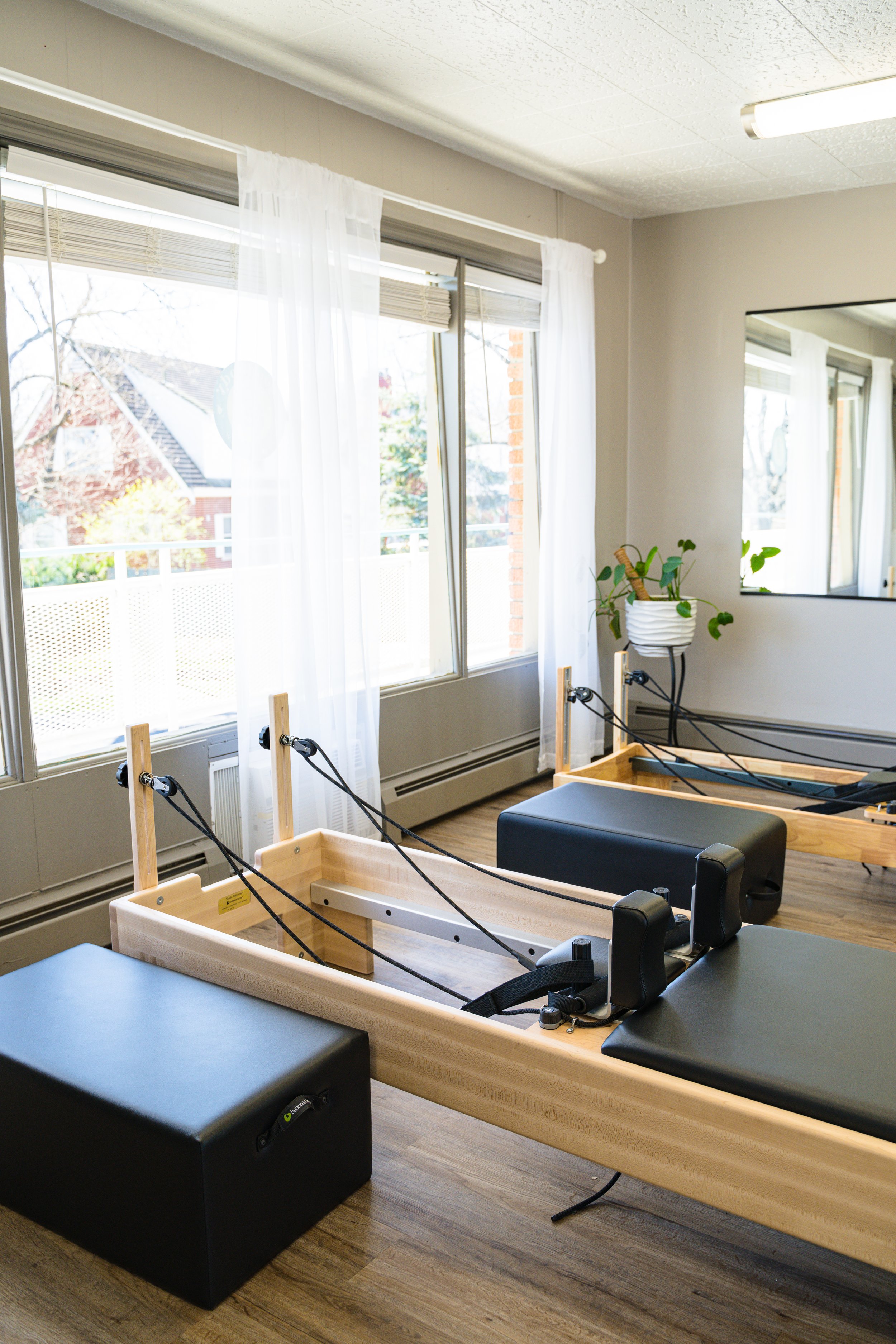Two reformers with reformer boxes sitting next to them at goodbody pilates and flow in cincinnati ohio