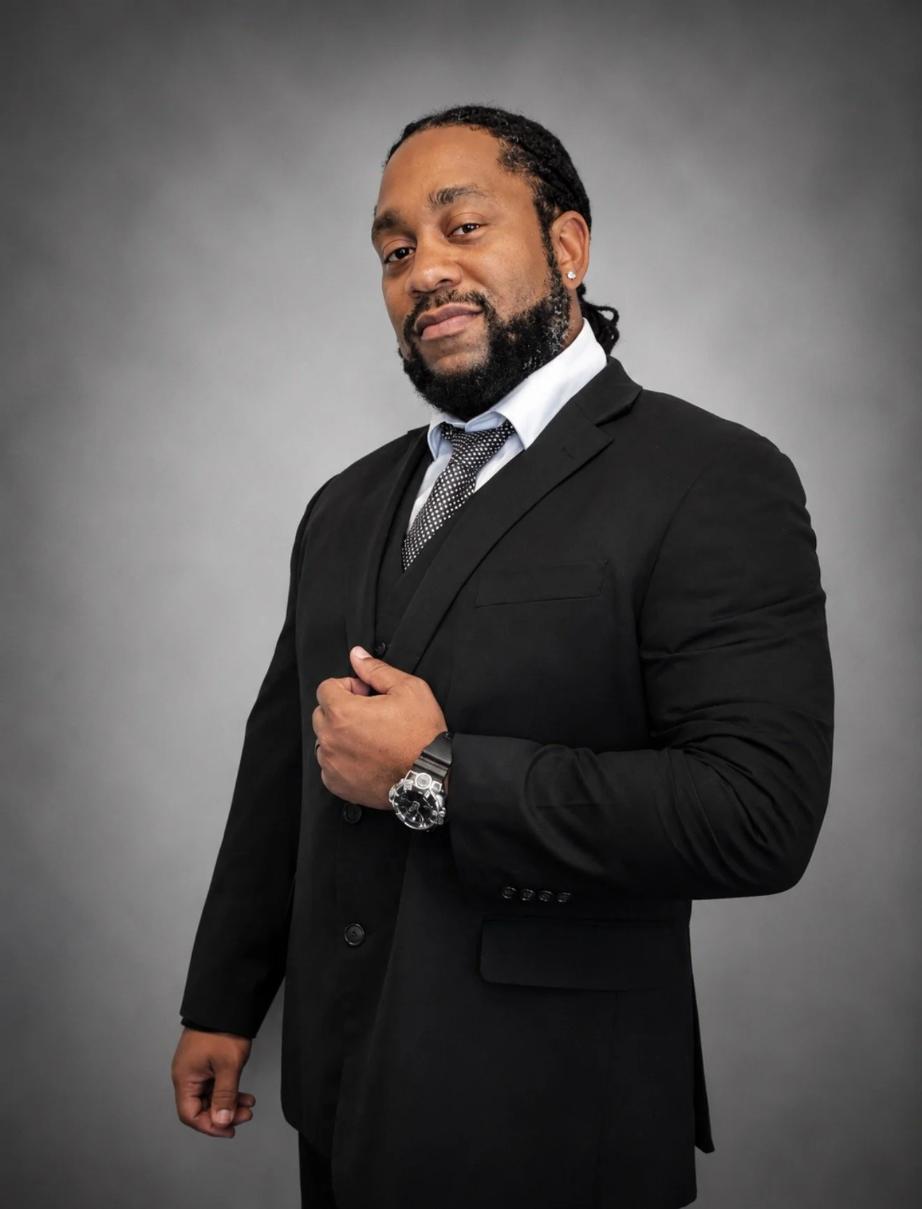 Professional picture, black man with braids, nice watch, nice grin, black suit and tie