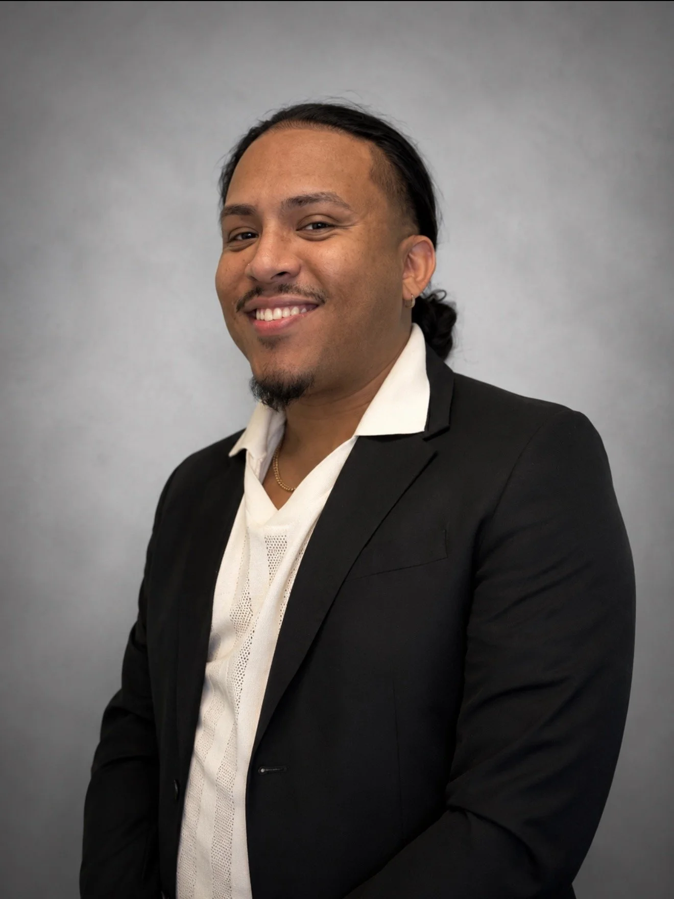 Professional picture, gray background, Hispanic man with, nice teeth, big smile, white shirt, black suit