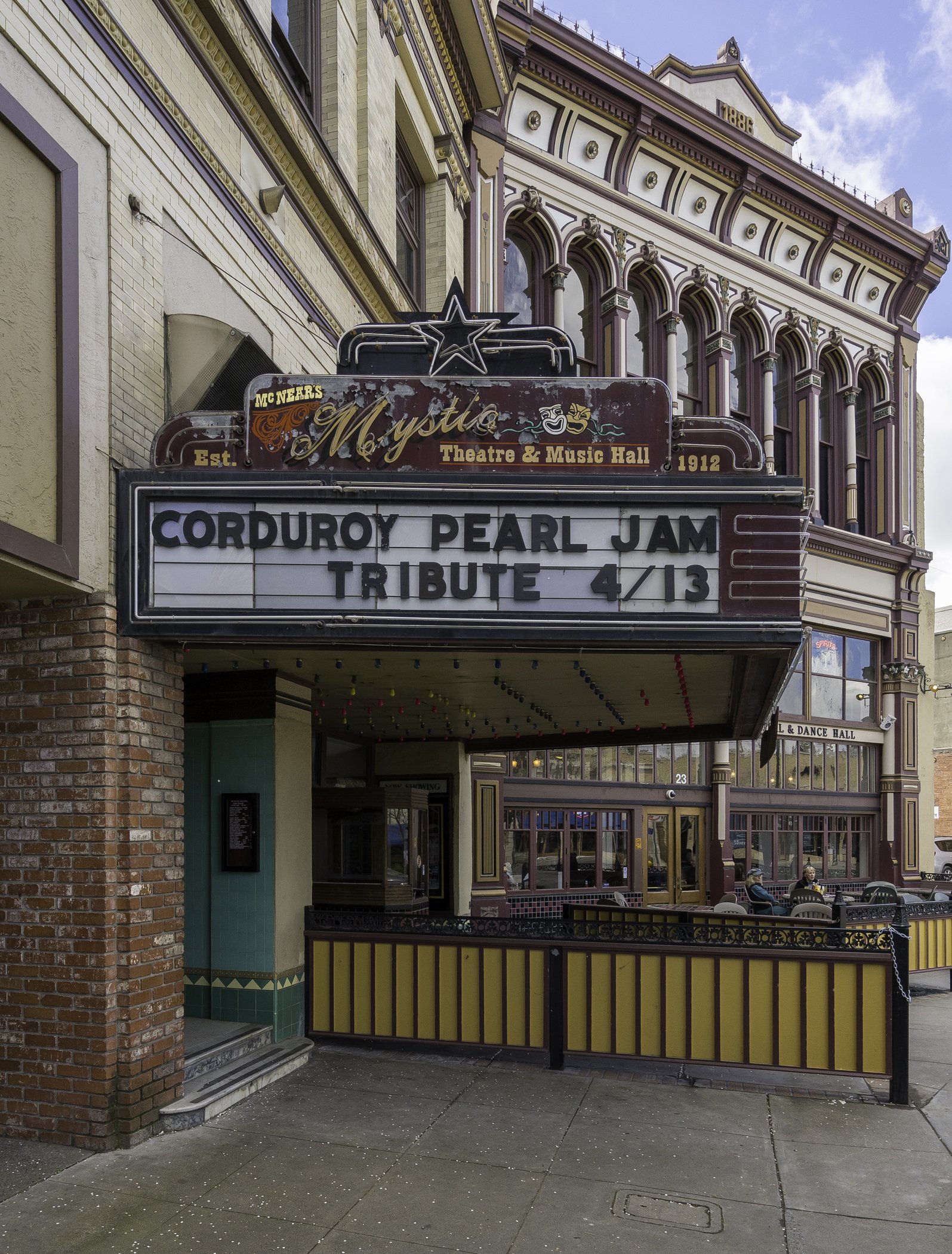 Exterior of McNear's Mystic Theatre and Music Hall with marquee advertising a Pearl Jam tribute event on April 13.