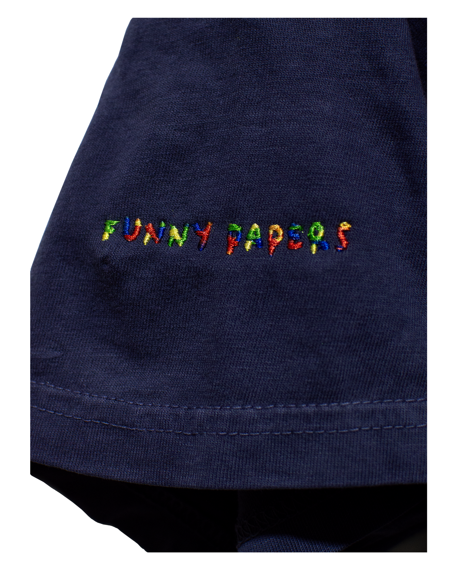 Detail of Washed Navy t-Shirt's right sleeve with "Funny Papers" embroidered on right sleeve in RGB variable thread