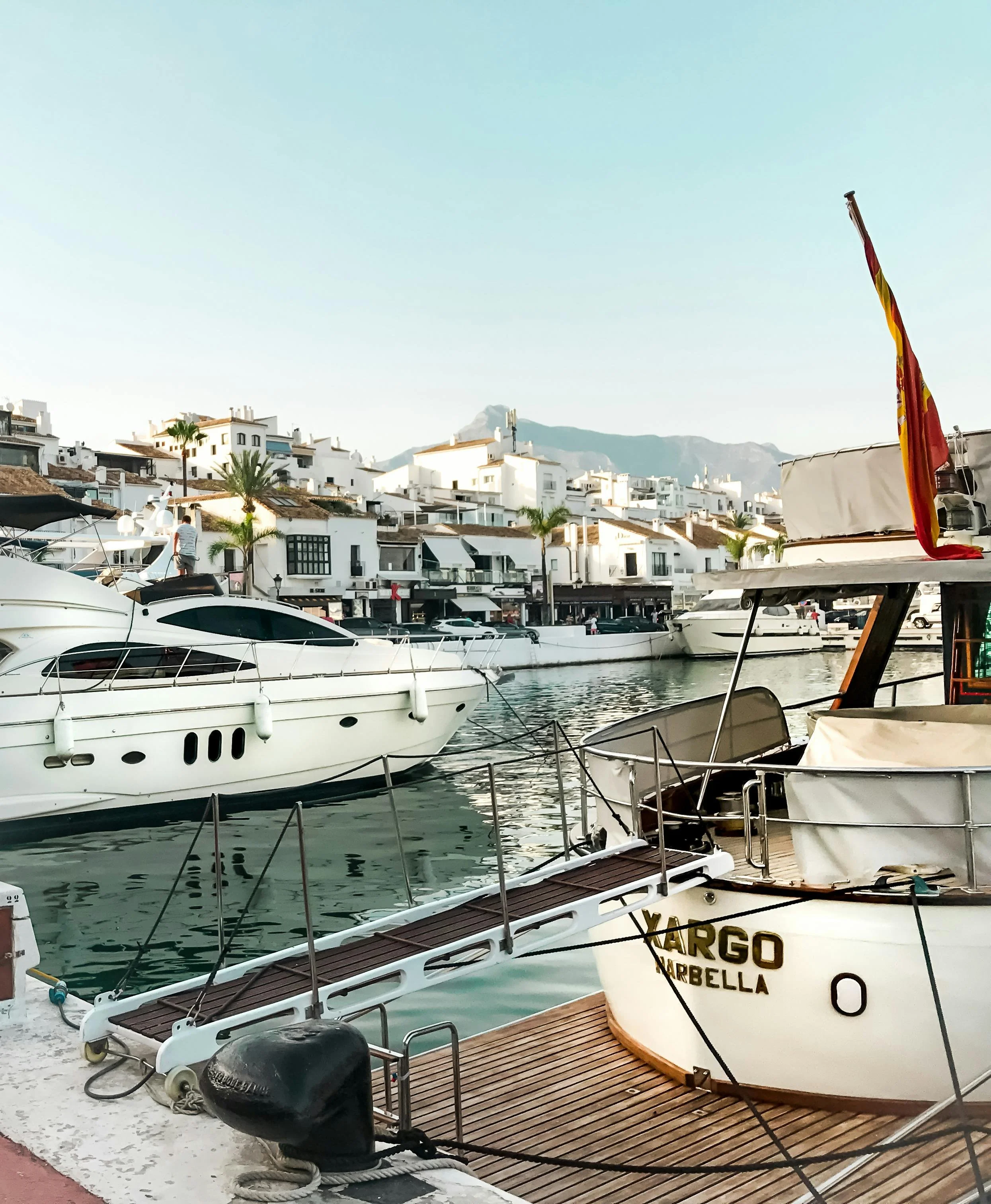Tropical shoreline with boats and jet skis — vibrant day on the water showcasing DXA’s luxury charters and ocean lifestyle.