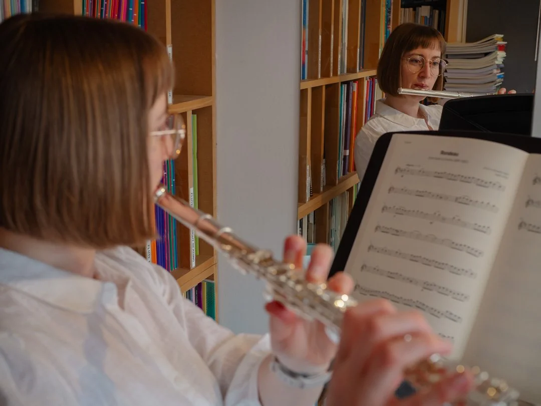 Reflective moment during a flute lesson, illustrating the journey of an adult learner in music