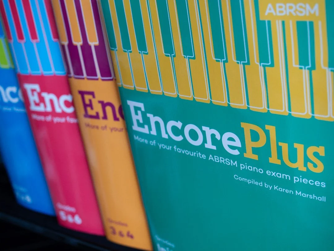 Front cover of ABRSM Encore Plus, a series of piano sheet music books.
