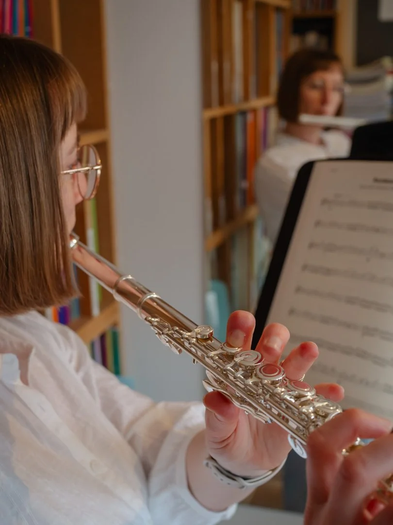 Clementine playing the flute during an adult music lesson, reflecting the experience of learning music later in life