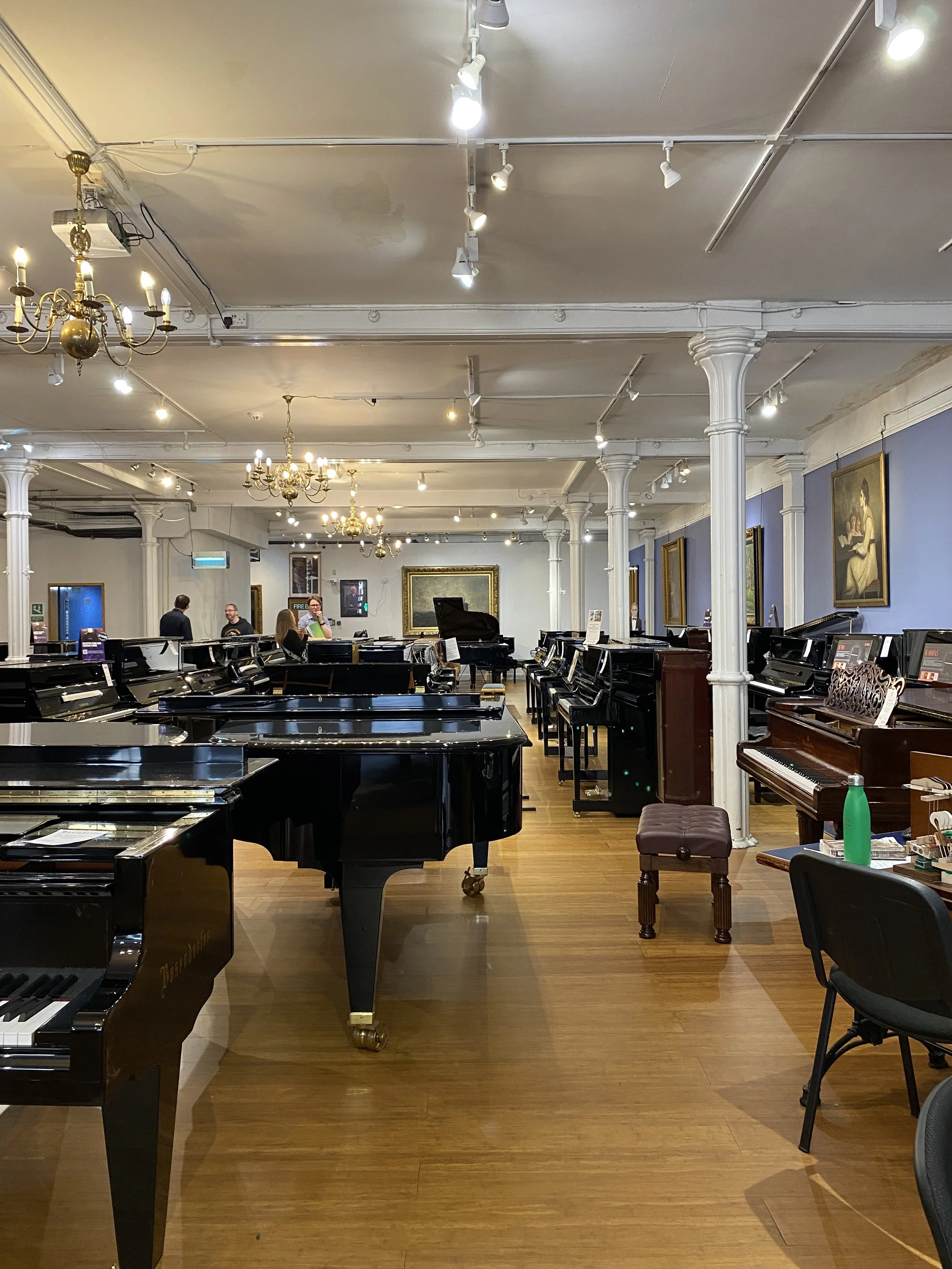Upright and grand pianos in the piano department at Forsyths Manchester
