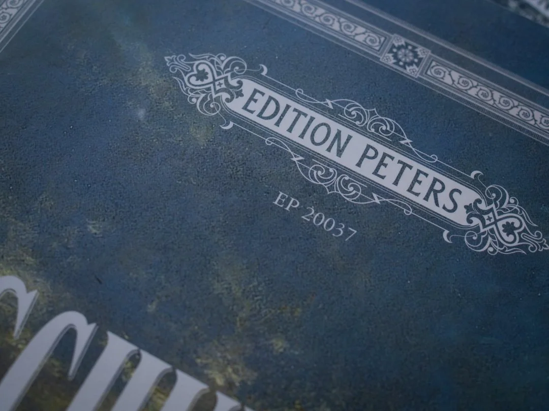 Close-up of the Edition Peters logo on printed piano sheet music