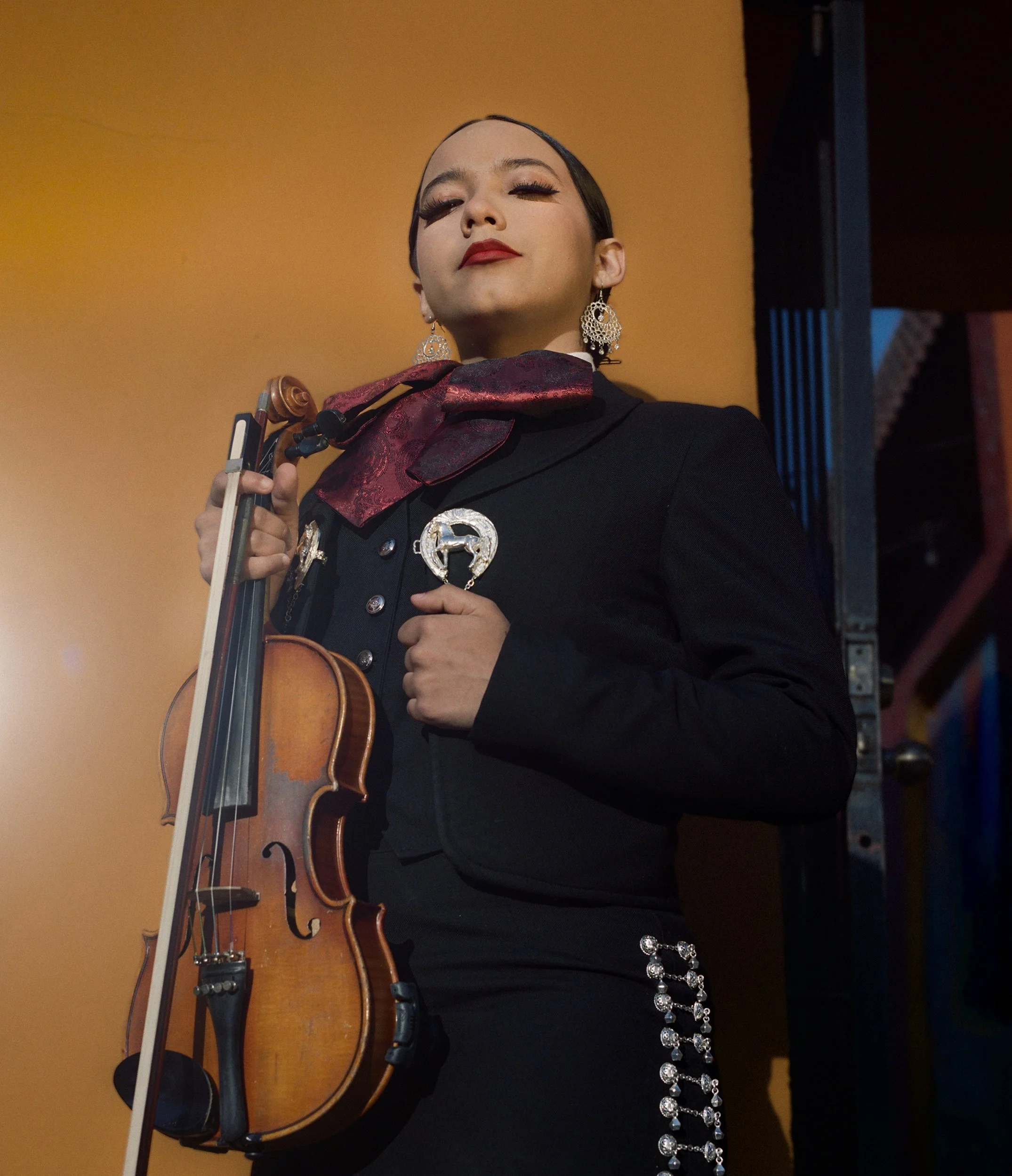 Mia Dalziel, 2026
 
20 x 16 inches
 
First-generation mariachi musician. Member of Mariachi Tecuala. 
 
 
“Mariachi music is more than just music to me; it's part of who I am, connecting me to my culture, my roots, and the people who have raised me.”