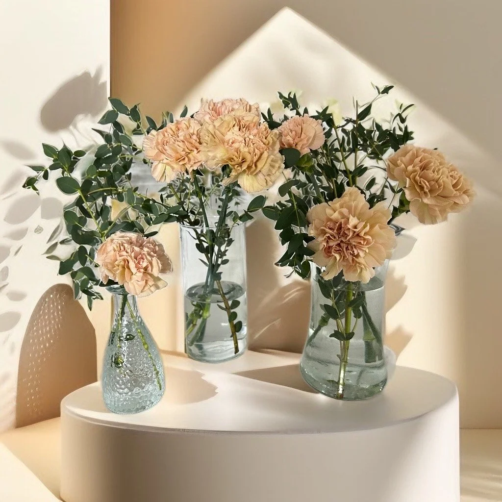 Three neutral flower arrangements with soft carnations