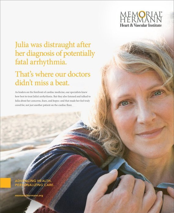 A smiling middle-aged woman with blonde hair outdoors, with a beach in the background, promoting heart health awareness for Memorial Hermann Heart & Vascular Institute.