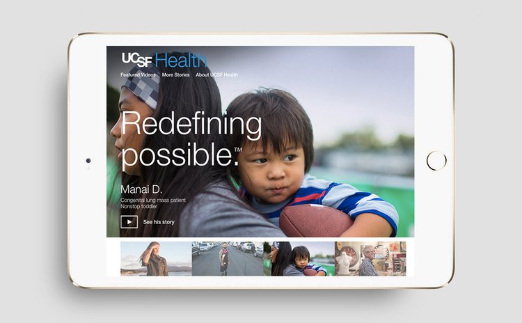 Tablet displaying the UCSF Health website with a large image of a young boy holding a football and a healthcare worker, with the tagline "Redefining possible."