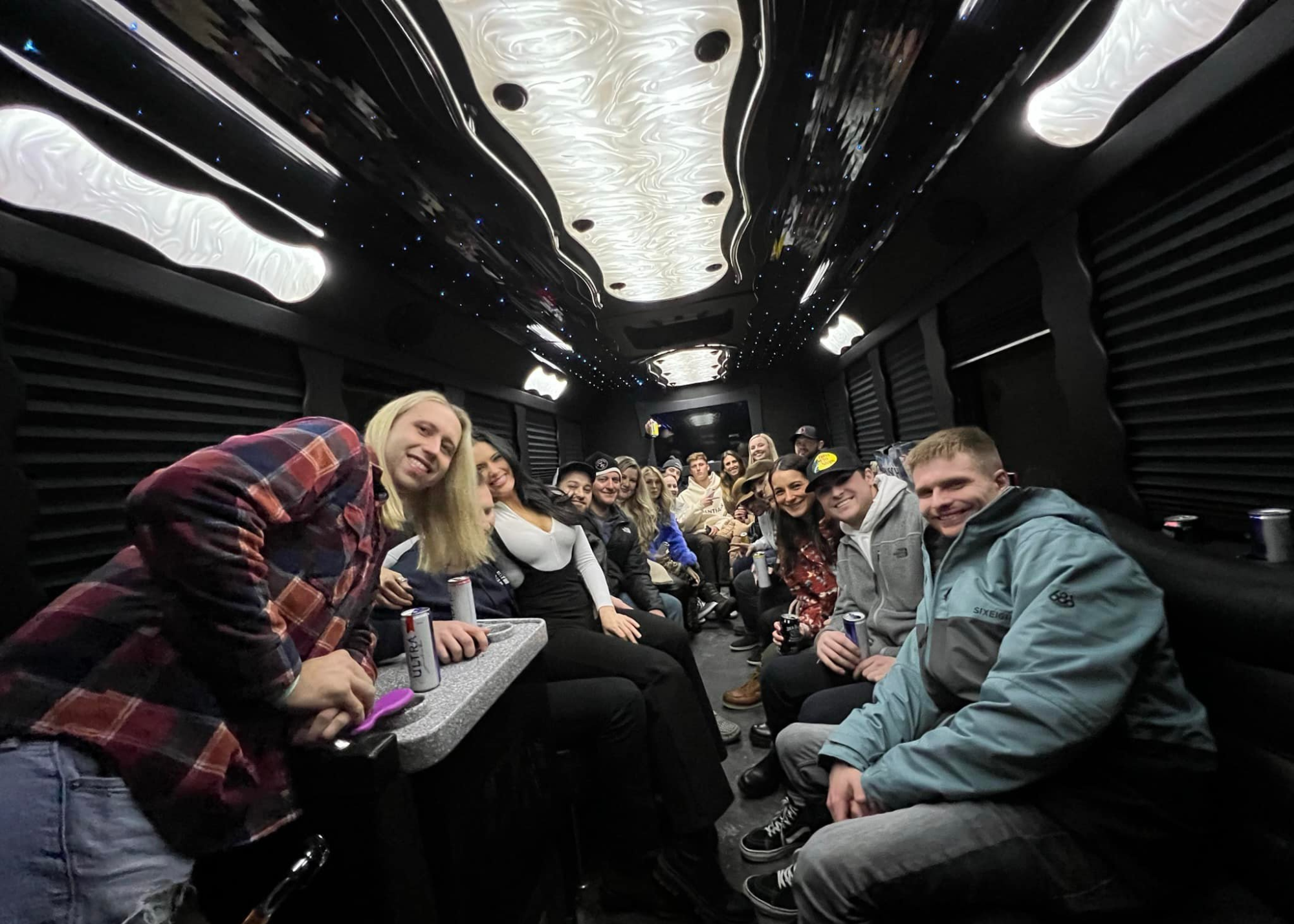 Group of friends celebrating on a party bus night out in Okoboji, Iowa