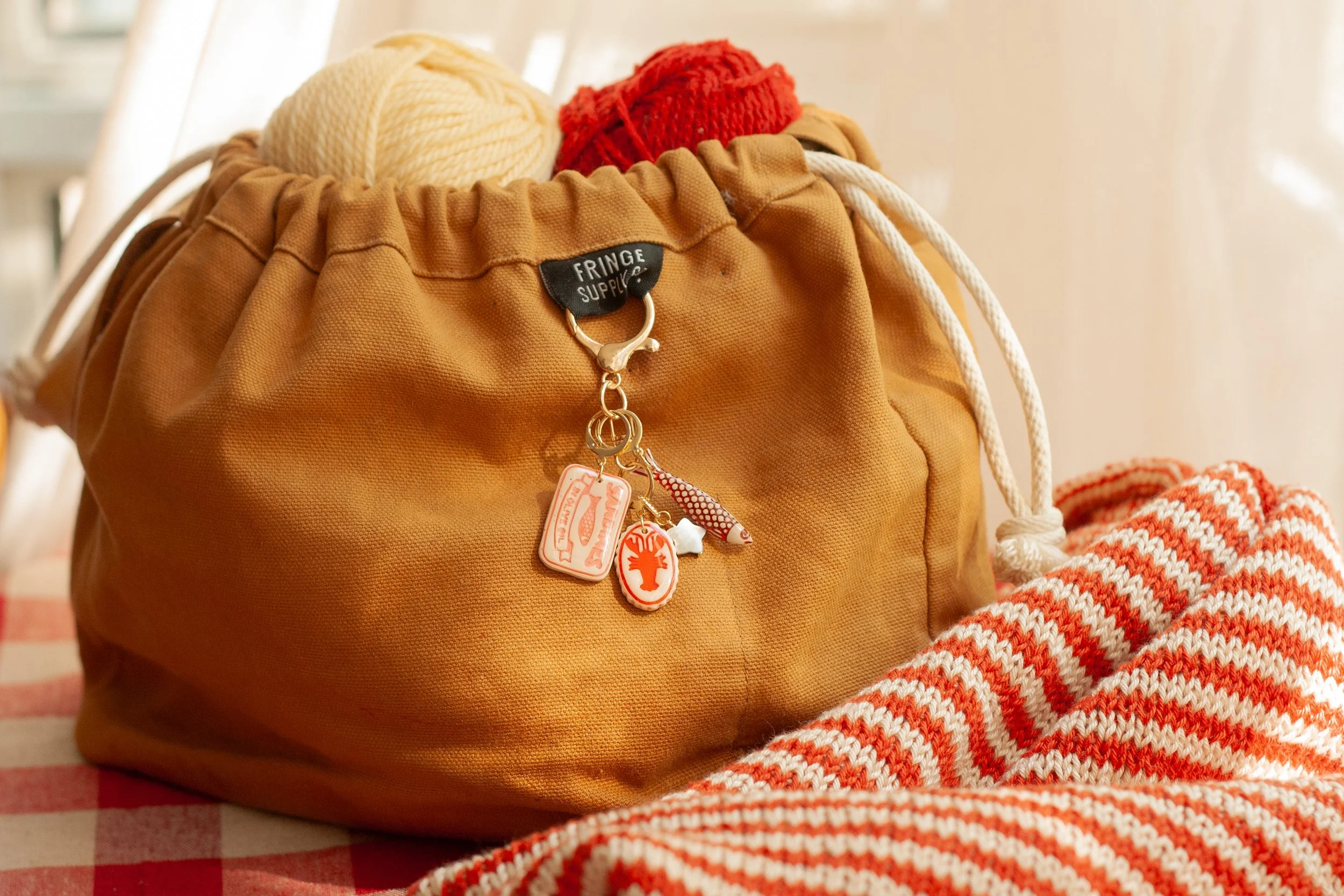 The Knitter’s Bag Charm in Coral, Red, and Burgundy