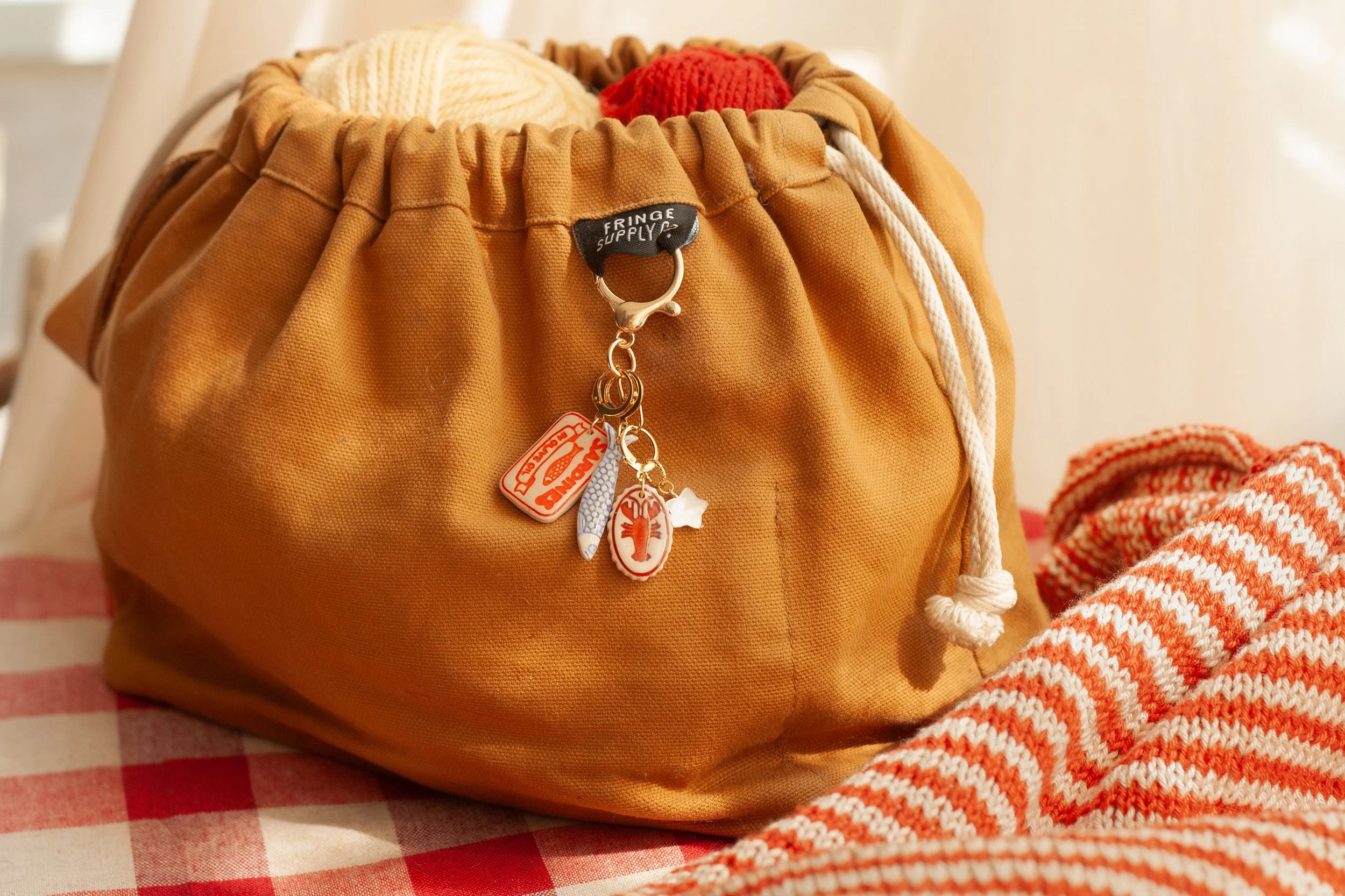 The Knitter’s Bag Charm in Red, Blue, and Burgundy