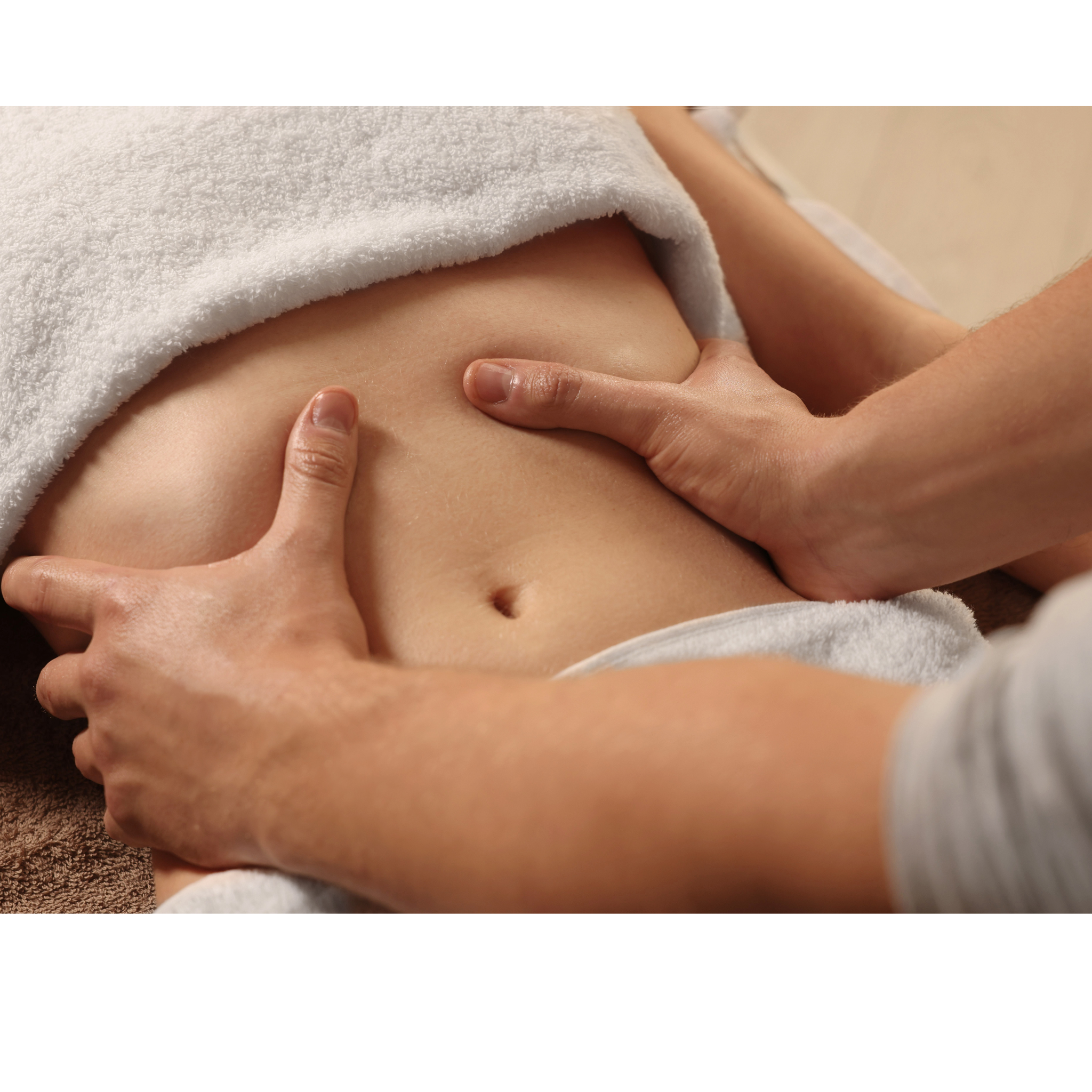 Person receiving a massage or physical therapy on their abdomen in a spa or clinic setting, with hands gently pressing on the stomach area.