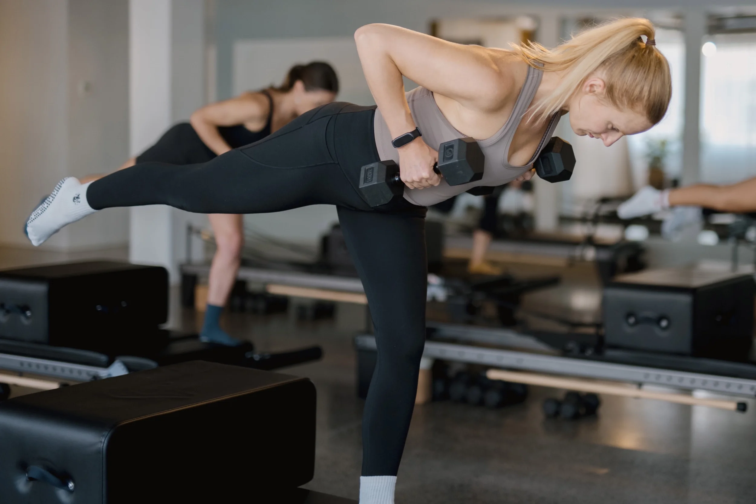 Reformer beds lined up on the studio floor at Reform Pilates, Twenty Two Mokoia