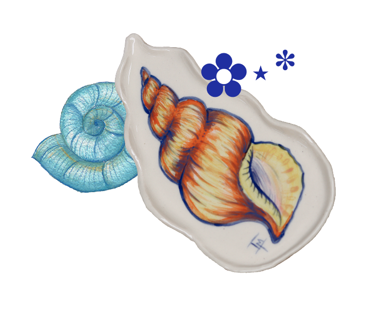 Colorful ceramic shell-shaped dish with a painted conch shell design and a smaller blue shell in the background.