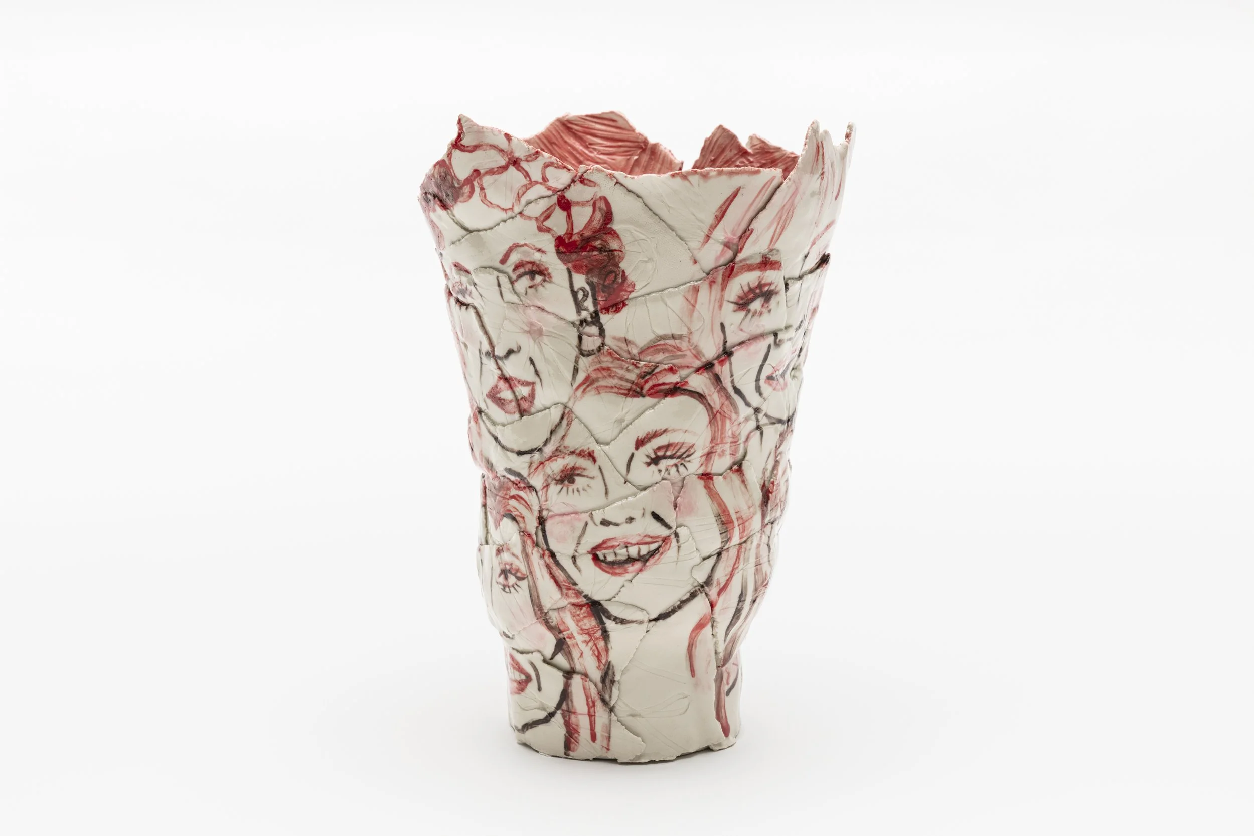 Ceramic vase decorated with endearing sketched portraits of women in black and red, on a white background.