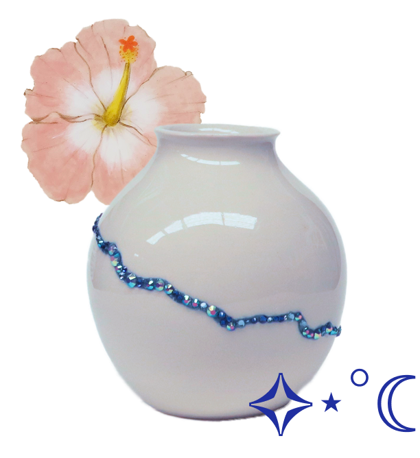 White ceramic vase with a blue decorative line, pink hibiscus flower behind it, set against a transparent background.