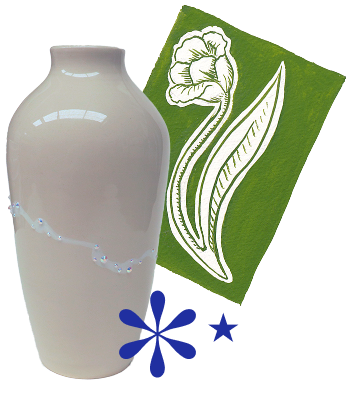 A white ceramic vase, a green card with a white flower and leaf printed on it.