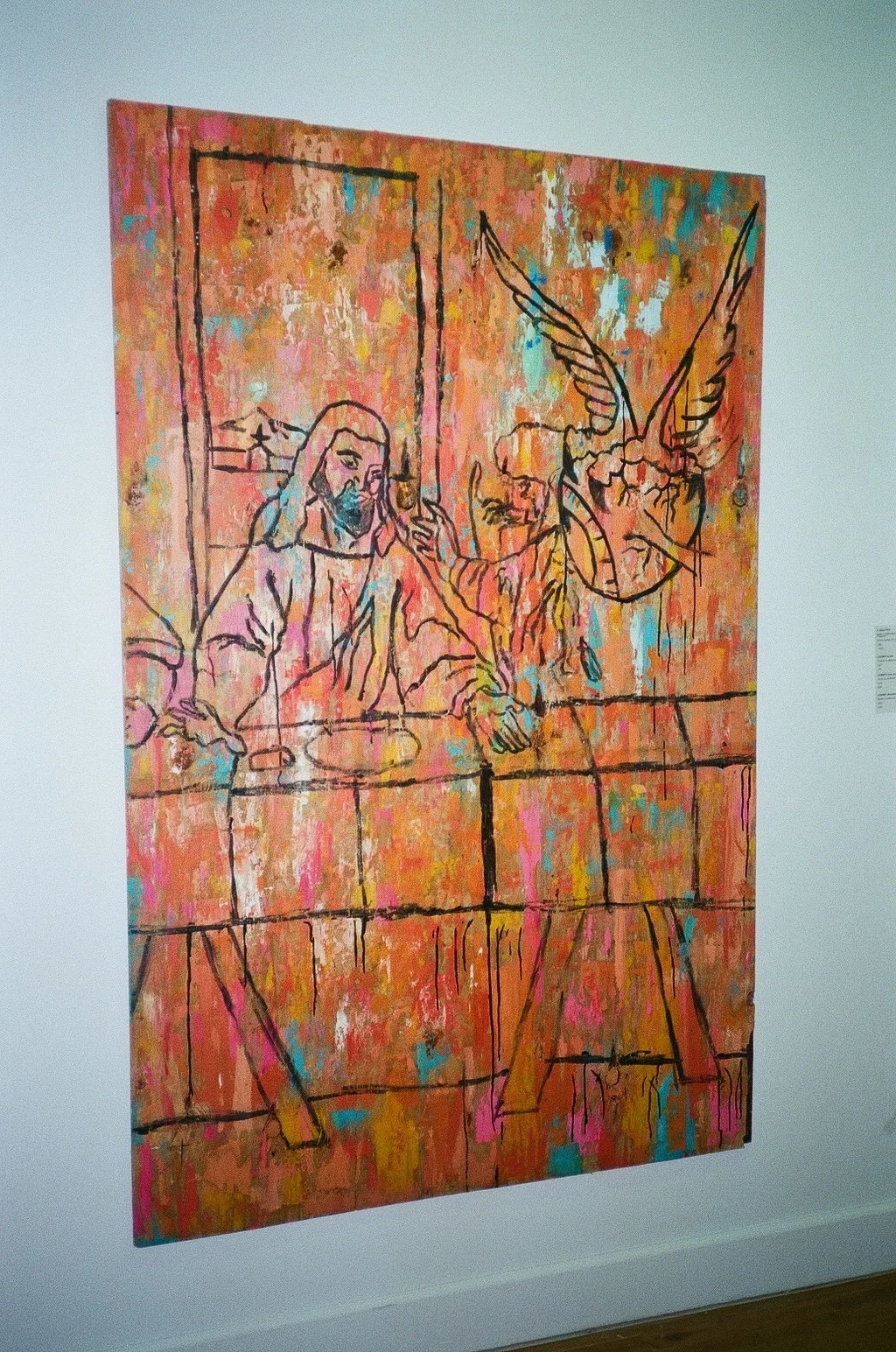 Abstract painting depicting two figures at a table, one with long hair and the other with wings and a horn, with a colorful background.