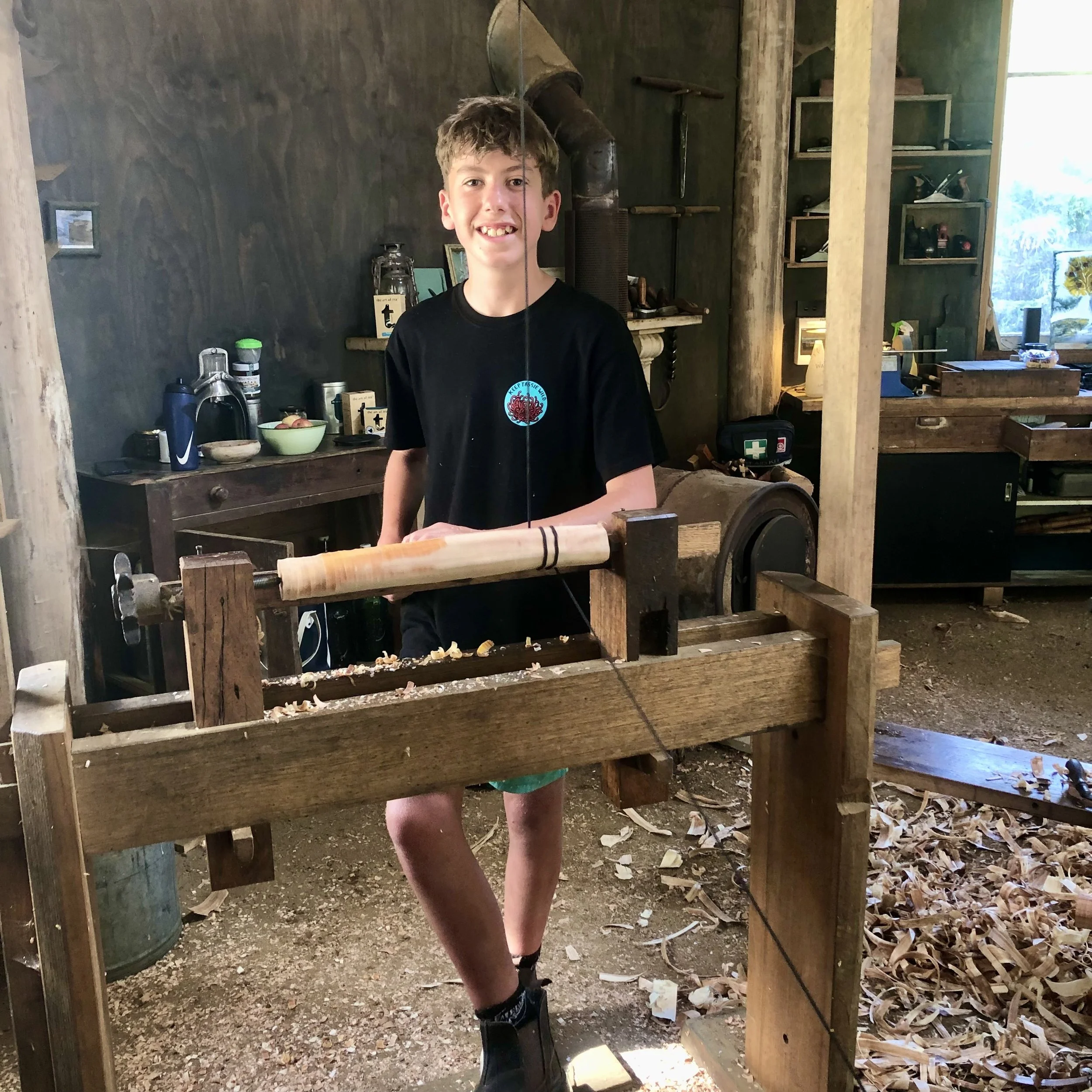 Workshop participant enjoying the pole-lathe-turning day course in the Wisdom Through Wood workshop.