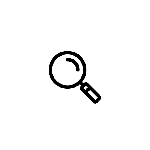 Modern cabin with wood paneling in a mountainous landscape, featuring a large window and surrounding vegetation.