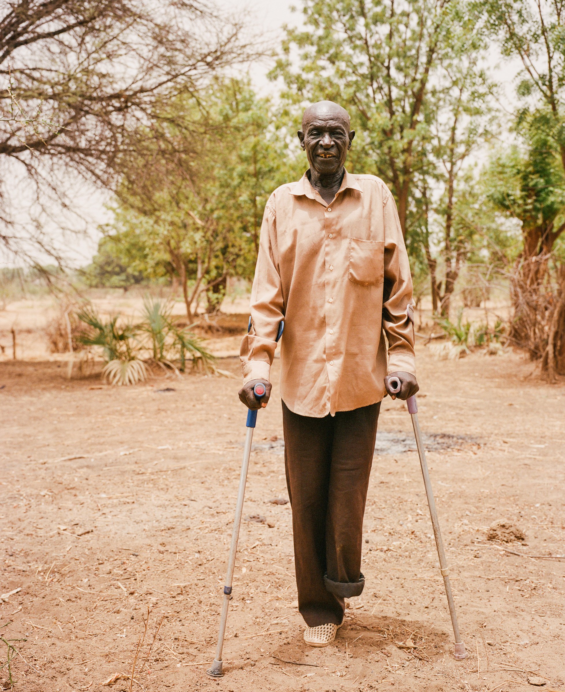 Adam Kuku stands at the location where a barrel bomb was dropped near his home in December 2023.