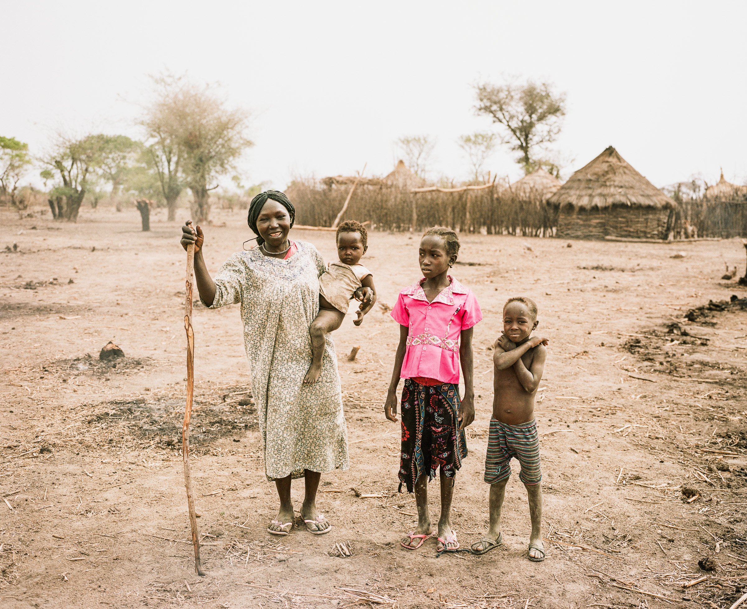 A mother and her chlidren prepare land for farming near Tujur, South Kordofan.