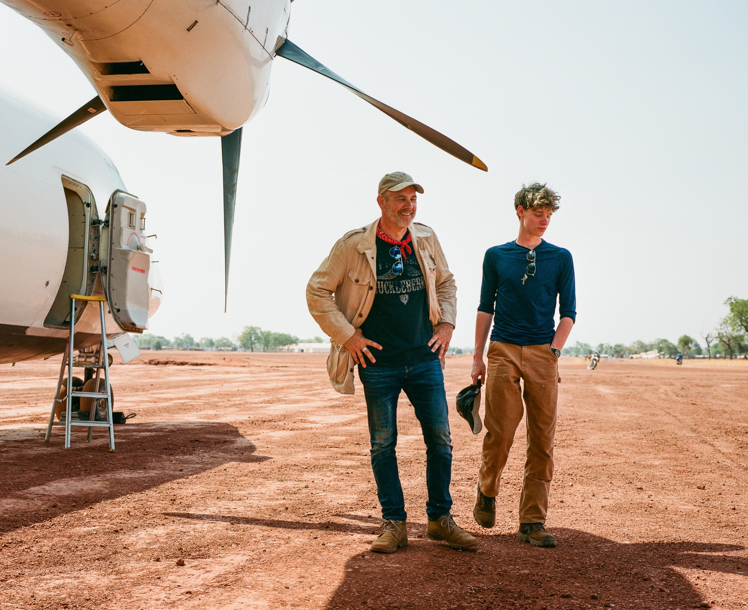 Executive Producer Matt Chancey and his son and (production assistant) Tucker on the Yida airstrip.