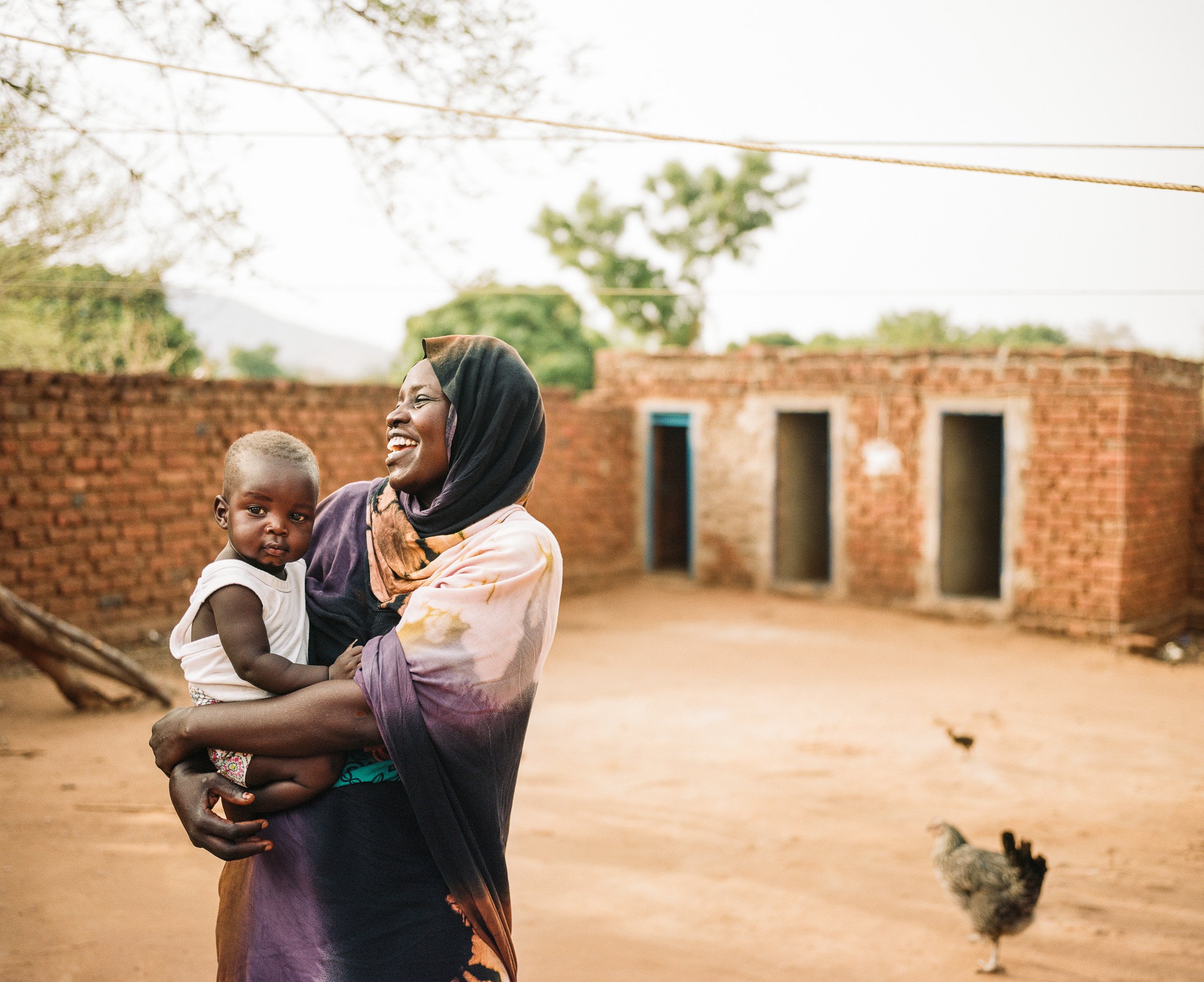 Rufa Mohammud holds her son Evin 'Ya Ya' Ibrahim in the compound of her relatives, where she is temporarily living.