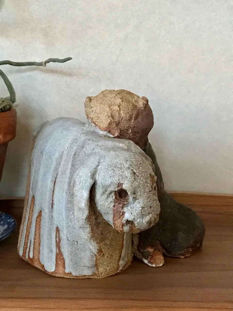 jente og kanin i steingodsleire, jentefigur i brun glasur, kanin i lysgrå glasur, står på hylle