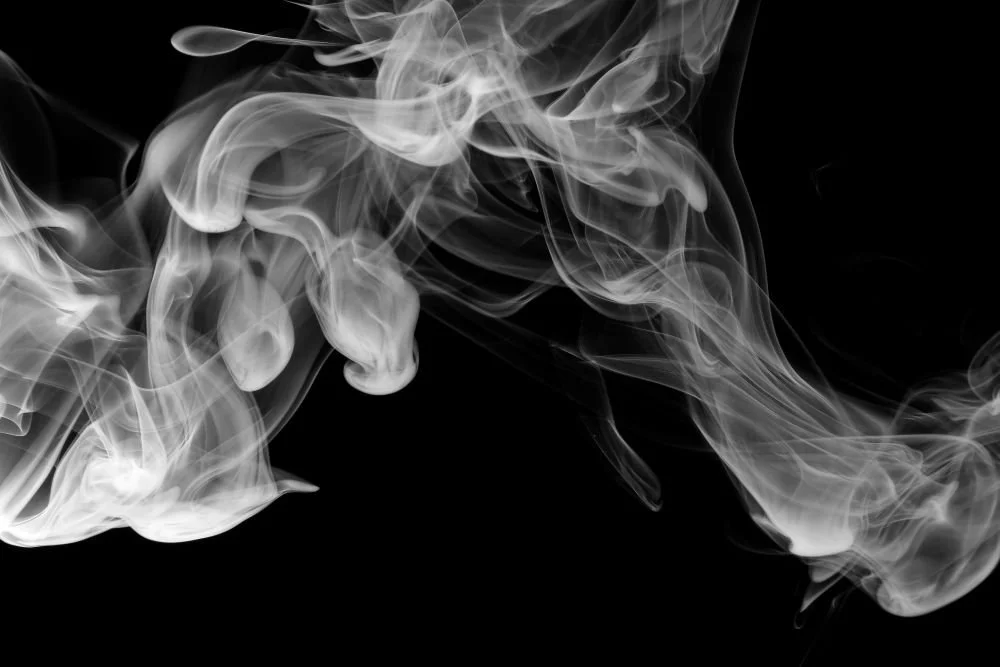 Black and white smoke representing Flowing, the rhythm of grounding, connection and returning to the body