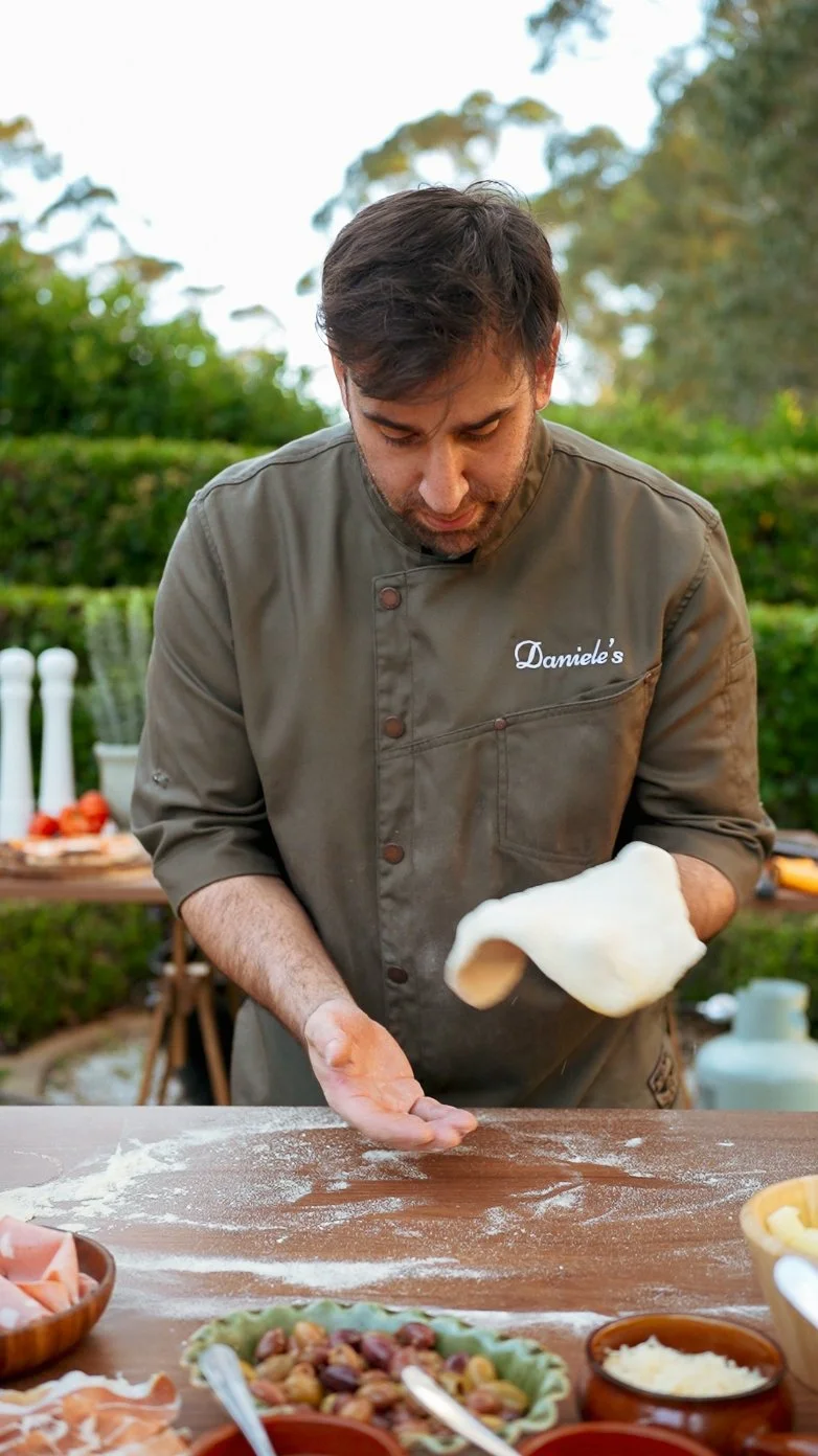 Daniele Luca live pizza catering cooking at a home event in sydney nsw wearing khaki branded chef jacket