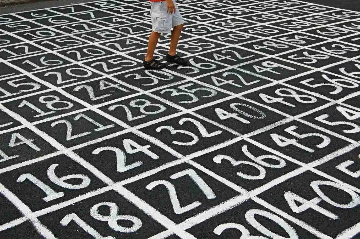 A child walking on top of a grid of numbers