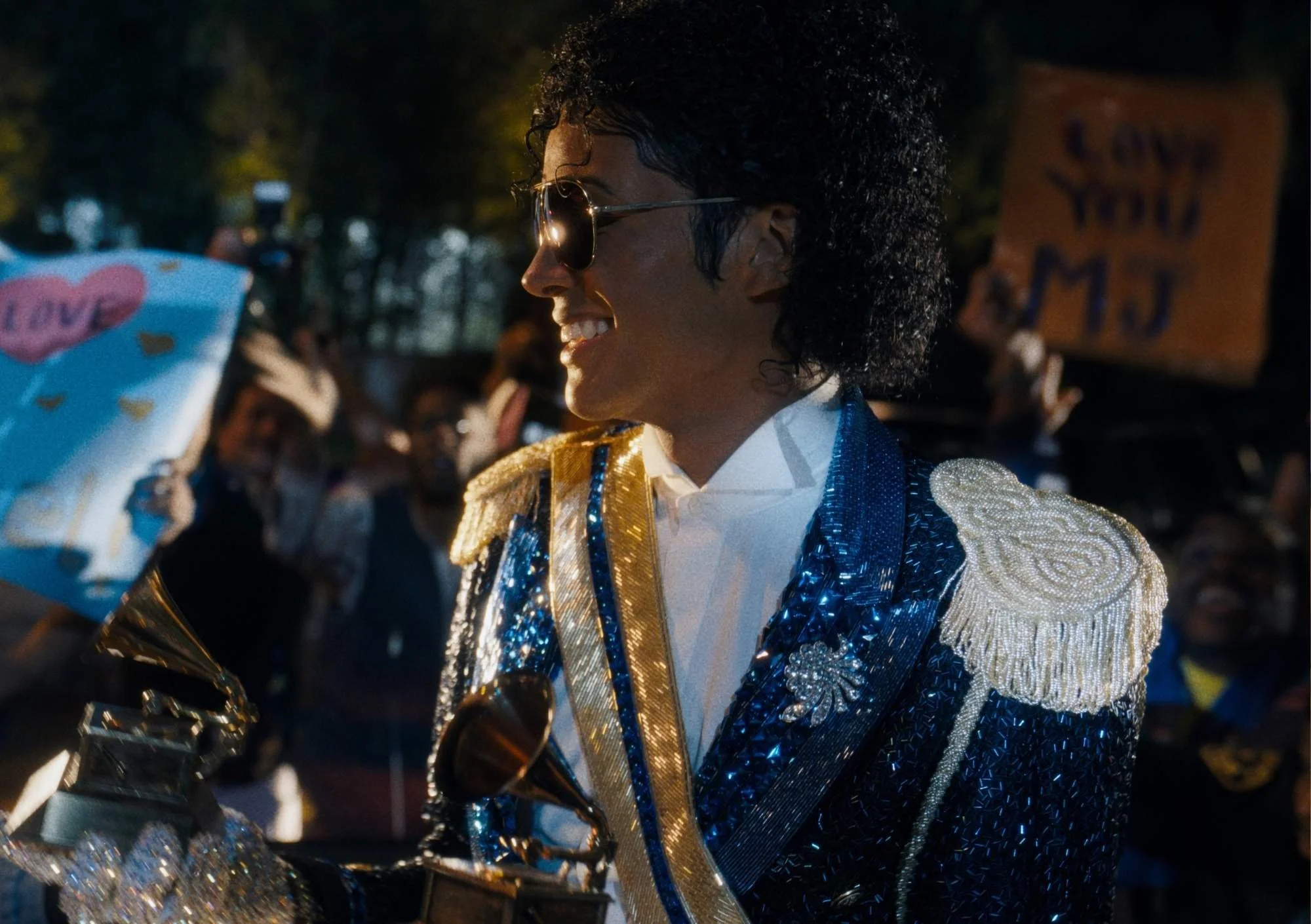 shows the star of Michael in the blue sparkly suit and surrounded by fans