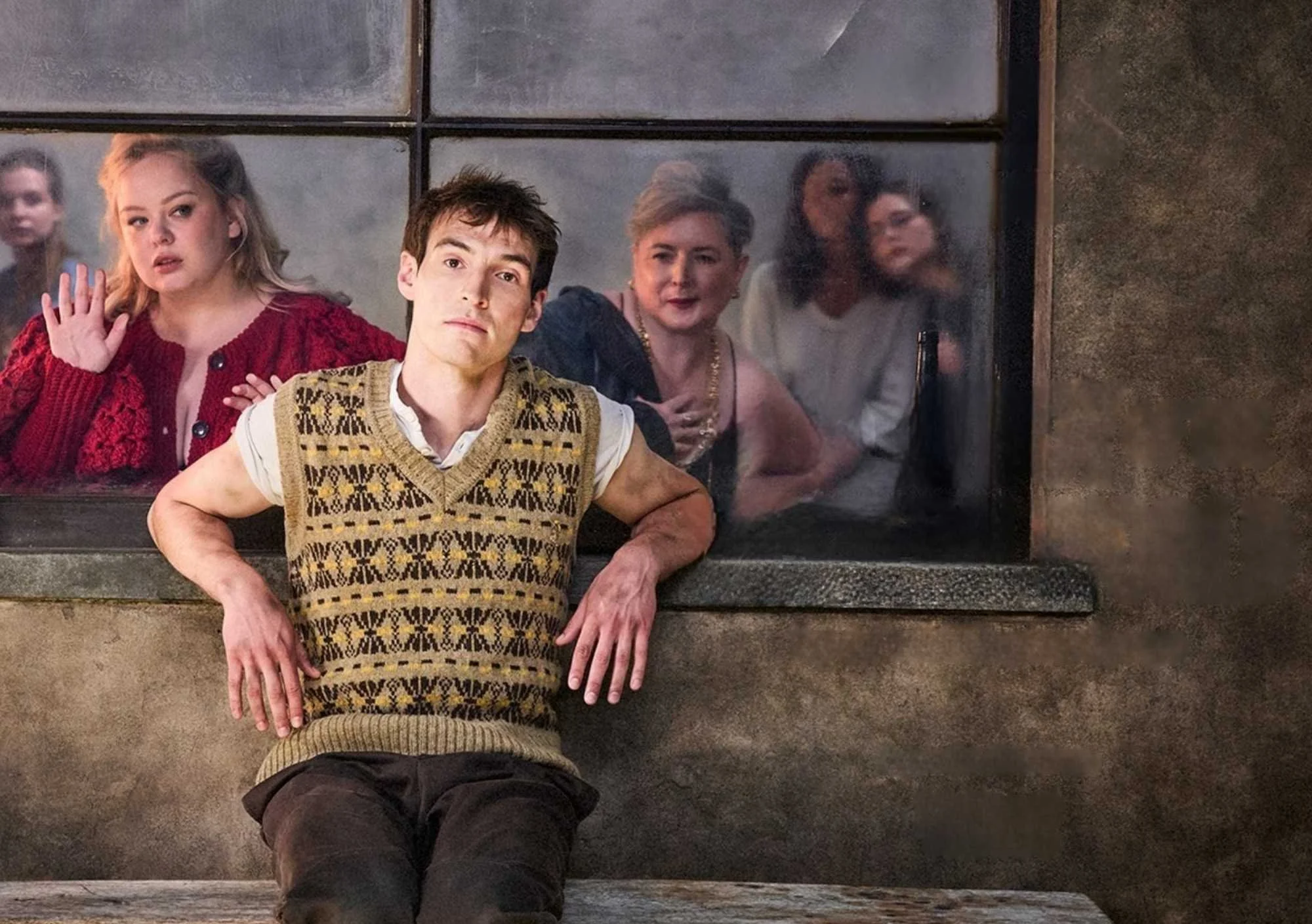 image shows man outside the window with other people on the other side