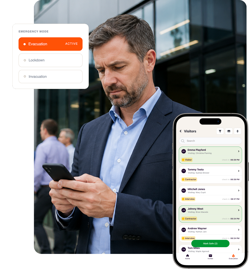 A man looking down at his phone to manage an evacuation