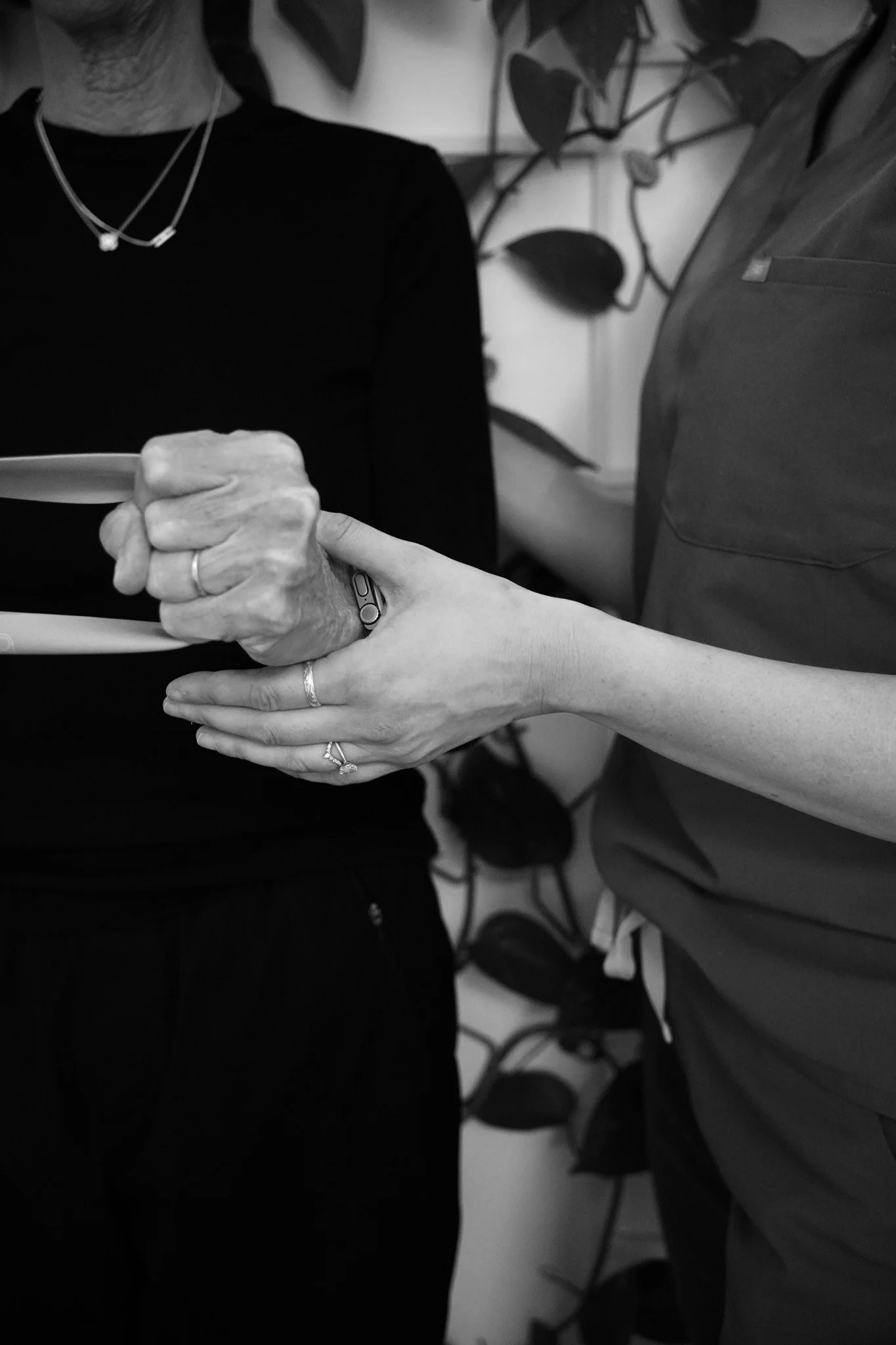 Physical therapist guiding a client through resistance band exercises to improve strength and mobility