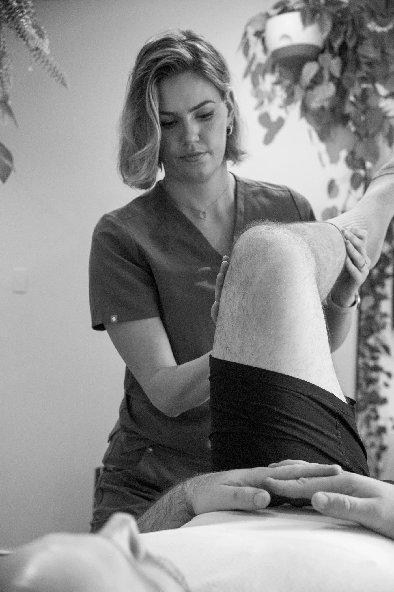 Physical therapist performing manual therapy on a patient’s leg