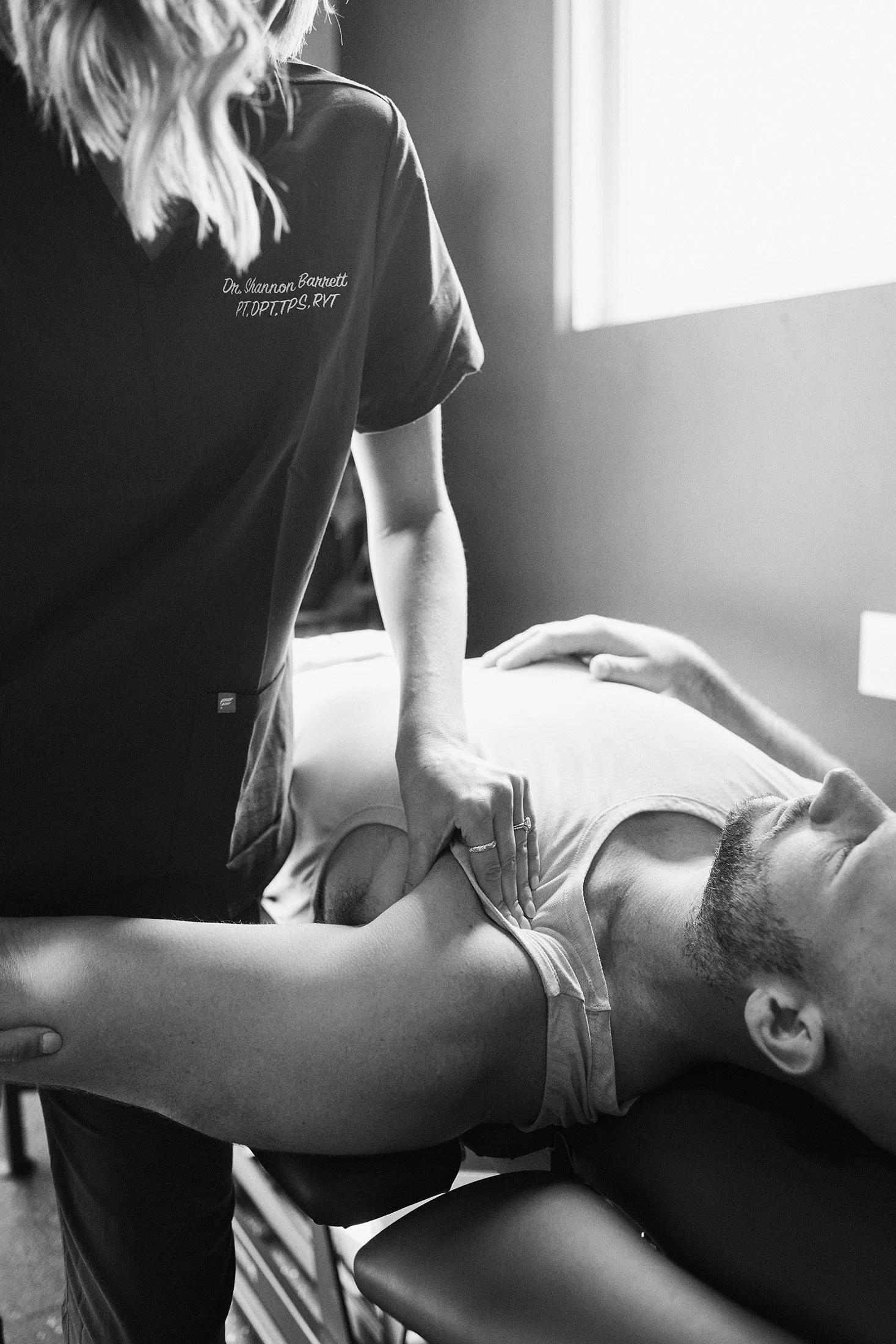 Physical therapist performing manual therapy to the upper body