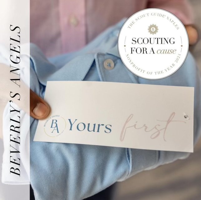 Person in a light blue shirt holding a card that says "Yours first" with a logo, and a round sticker that reads "The Scout Guide Naples, Scouting for a cause, Support of the team 2024." The background is blurred.