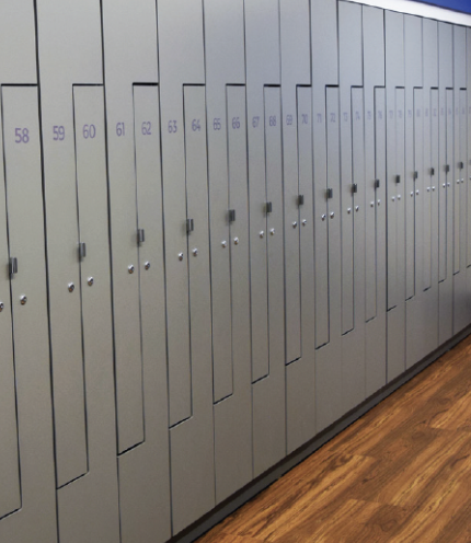 Empty store shelving unit with blue sliding doors, some white shelves, and a black handle, with a small cardboard box on the bottom shelf.